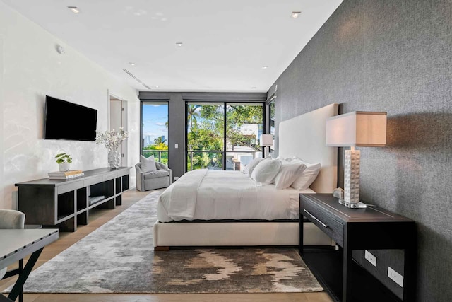 121 2nd Dilido Ter Share B, Unit Share B, Miami Beach, FL 33139 - bedroom with access to exterior, wood finished floors, an accent wall, and recessed lighting