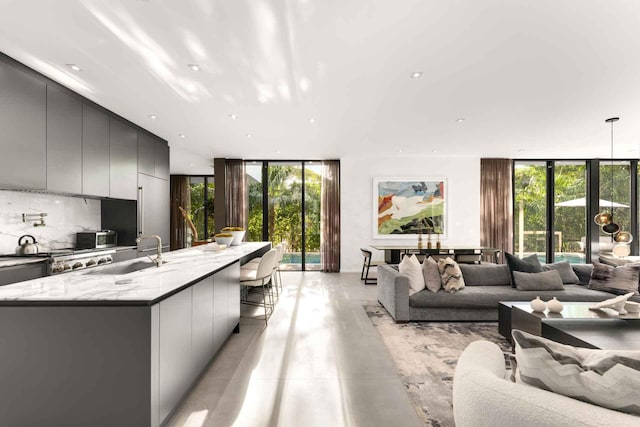 121 2nd Dilido Ter Share B, Unit Share B, Miami Beach, FL 33139 - living room featuring floor to ceiling windows, plenty of natural light, finished concrete floors, and recessed lighting