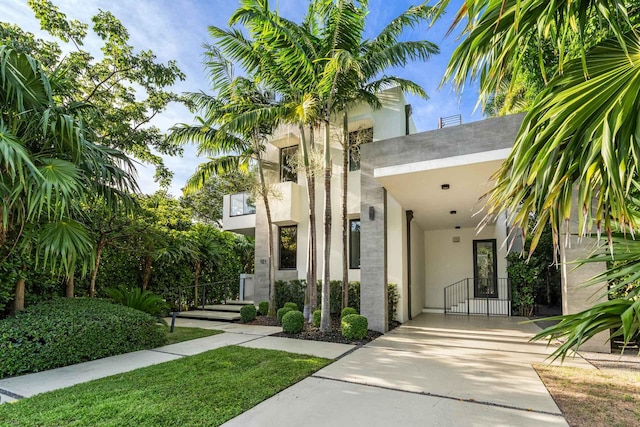 121 2nd Dilido Ter Share B, Unit Share B, Miami Beach, FL 33139 - view of front of property featuring a gate, stucco siding, concrete driveway, and an attached carport