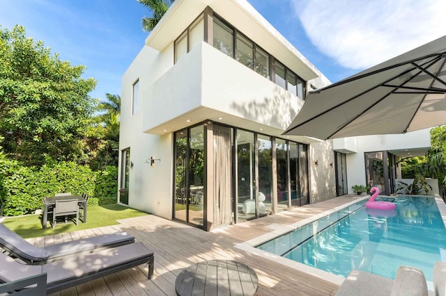 121 2nd Dilido Ter Share B, Unit Share B, Miami Beach, FL 33139 - rear view of property with a wooden deck, stucco siding, and an outdoor pool