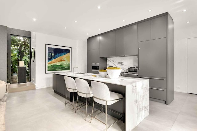 121 2nd Dilido Ter Share B, Unit Share B, Miami Beach, FL 33139 - kitchen with modern cabinets, gray cabinets, oven, a spacious island, and recessed lighting
