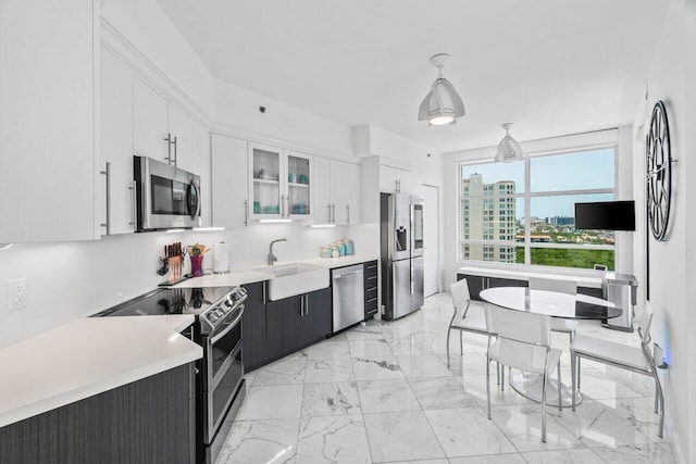 3700 S Ocean Blvd Unit 1210, Highland Beach, FL 33487 - kitchen with stainless steel appliances, a sink, light marble finish floors, and light countertops