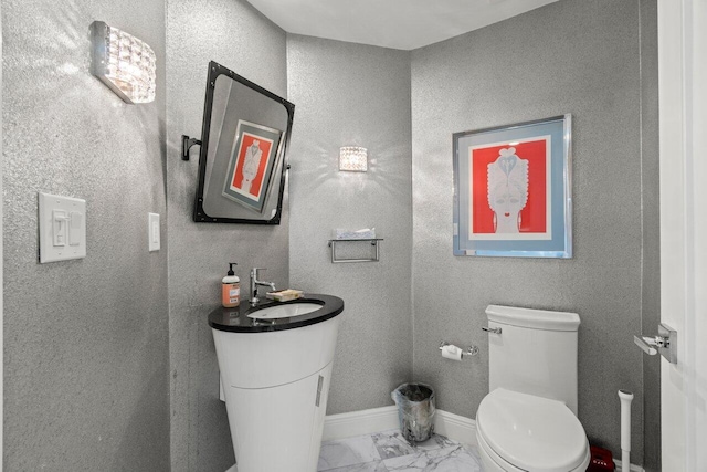3700 S Ocean Blvd Unit 1210, Highland Beach, FL 33487 - half bathroom featuring marble finish flooring, toilet, baseboards, and vanity