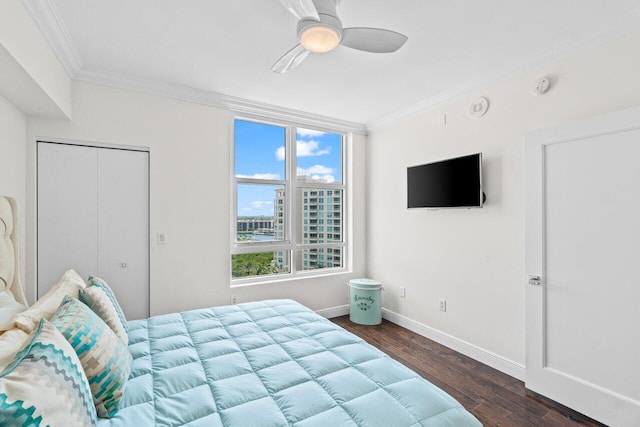 3700 S Ocean Blvd Unit 1210, Highland Beach, FL 33487 - bedroom featuring crown molding, dark wood-type flooring, baseboards, ceiling fan, and a closet
