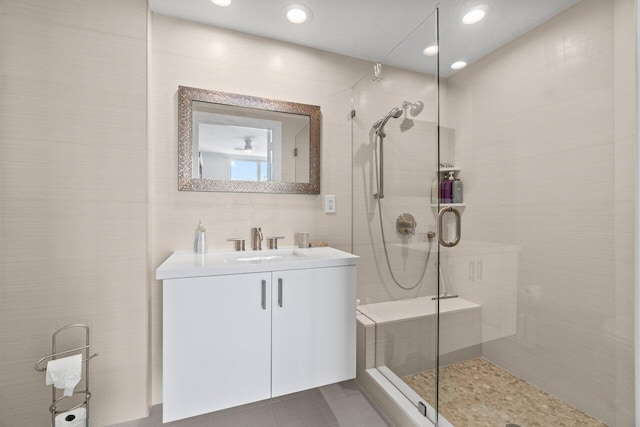3700 S Ocean Blvd Unit 1210, Highland Beach, FL 33487 - bathroom with vanity, tiled shower, recessed lighting, and tile walls