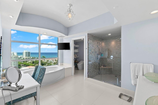 3700 S Ocean Blvd Unit 1210, Highland Beach, FL 33487 - bathroom featuring a shower stall, a bath, double vanity, tile patterned flooring, and vaulted ceiling