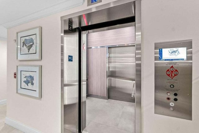 3700 S Ocean Blvd Unit 1210, Highland Beach, FL 33487 - elevator featuring baseboards and ornamental molding