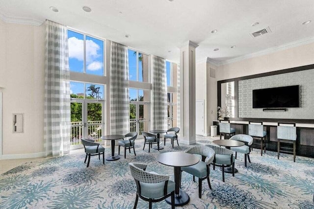 3700 S Ocean Blvd Unit 1210, Highland Beach, FL 33487 - living room featuring baseboards, a towering ceiling, ornate columns, carpet, and ornamental molding