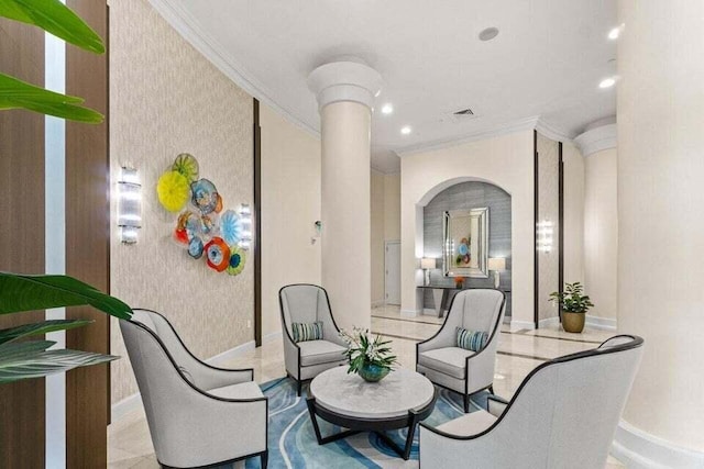 3700 S Ocean Blvd Unit 1210, Highland Beach, FL 33487 - living area with ornamental molding, baseboards, ornate columns, wallpapered walls, and arched walkways