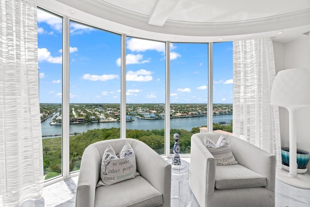 3700 S Ocean Blvd Unit 1210, Highland Beach, FL 33487 - sunroom featuring a water view, marble tiled flooring, and crown molding