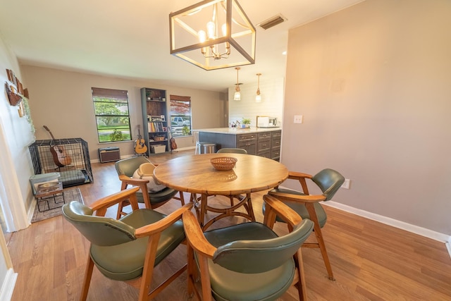1793 SW 22nd Ter, Okeechobee, FL 34974 - dining room featuring light wood-style floors, baseboards, and a chandelier