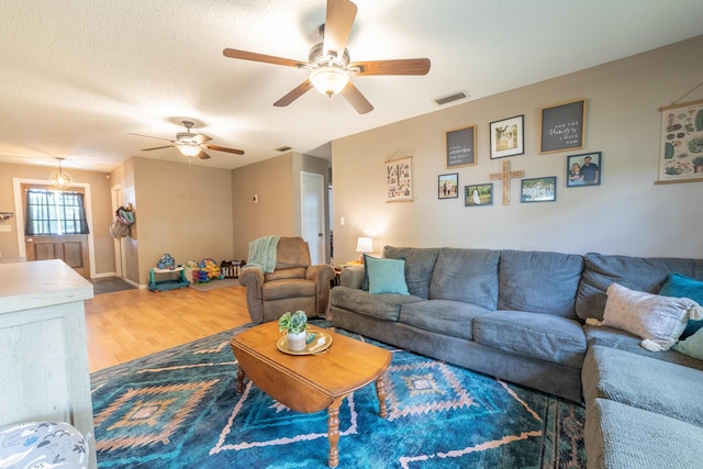 1793 SW 22nd Ter, Okeechobee, FL 34974 - living area featuring wood finished floors, a ceiling fan, and a textured ceiling