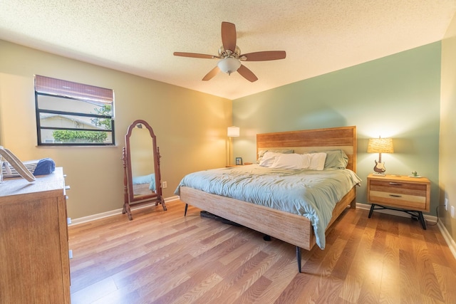 1793 SW 22nd Ter, Okeechobee, FL 34974 - bedroom featuring wood finished floors, baseboards, a textured ceiling, and a ceiling fan