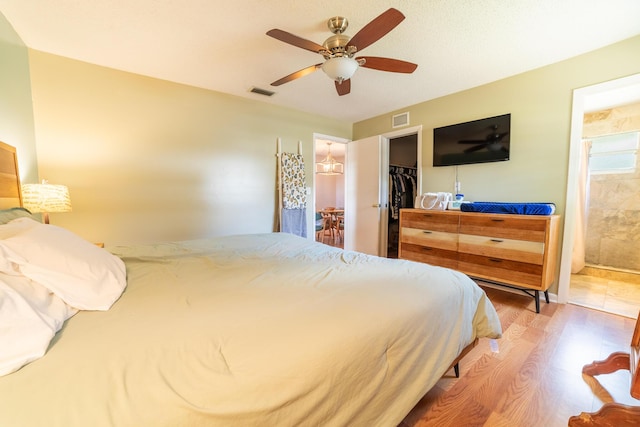 1793 SW 22nd Ter, Okeechobee, FL 34974 - bedroom featuring wood finished floors, a spacious closet, connected bathroom, a closet, and a ceiling fan