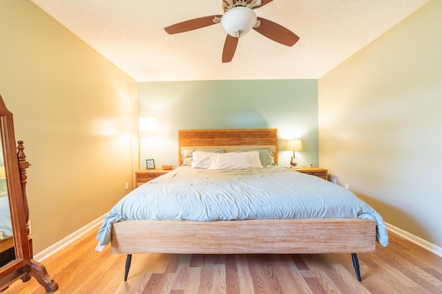 1793 SW 22nd Ter, Okeechobee, FL 34974 - bedroom featuring baseboards, wood finished floors, and a ceiling fan