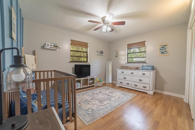 1793 SW 22nd Ter, Okeechobee, FL 34974 - bedroom featuring light wood-type flooring, a textured ceiling, baseboards, and ceiling fan