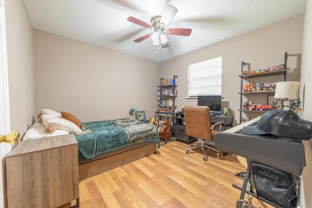 1793 SW 22nd Ter, Okeechobee, FL 34974 - bedroom featuring wood finished floors, an office area, a textured ceiling, and a ceiling fan