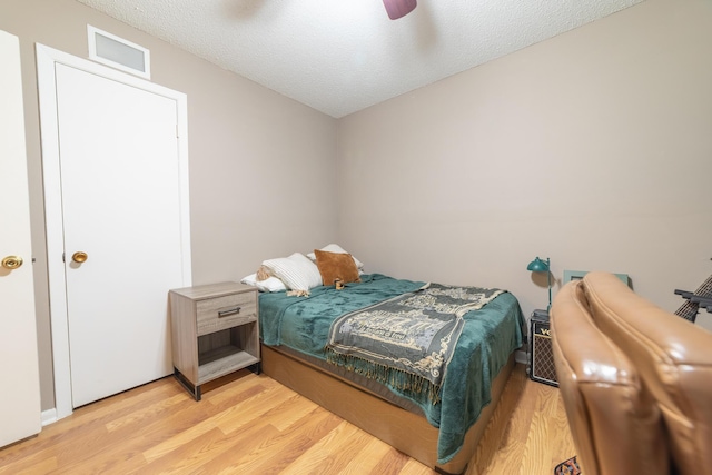1793 SW 22nd Ter, Okeechobee, FL 34974 - bedroom featuring light wood finished floors, ceiling fan, and a textured ceiling