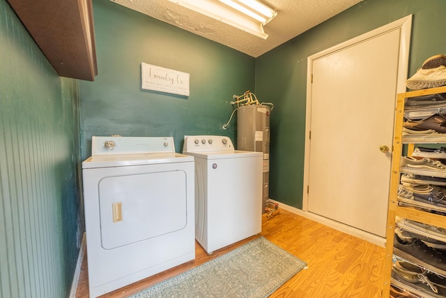1793 SW 22nd Ter, Okeechobee, FL 34974 - laundry room featuring light wood-style flooring, electric water heater, and separate washer and dryer