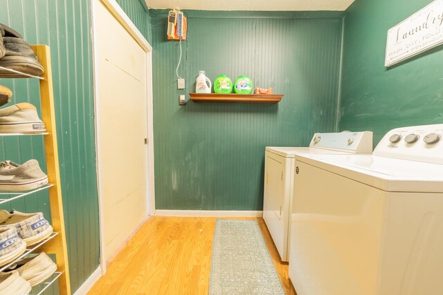 1793 SW 22nd Ter, Okeechobee, FL 34974 - laundry room with light wood-type flooring, washer and dryer, and baseboards