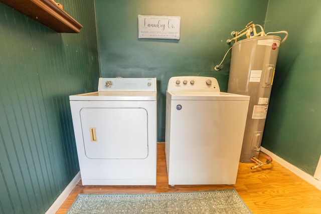 1793 SW 22nd Ter, Okeechobee, FL 34974 - laundry area featuring washing machine and clothes dryer, wood finished floors, water heater, and baseboards