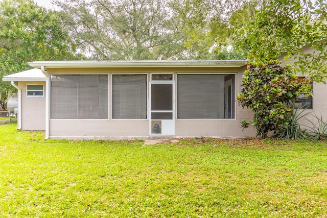 1793 SW 22nd Ter, Okeechobee, FL 34974 - view of home's exterior featuring a sunroom, a yard, and stucco siding