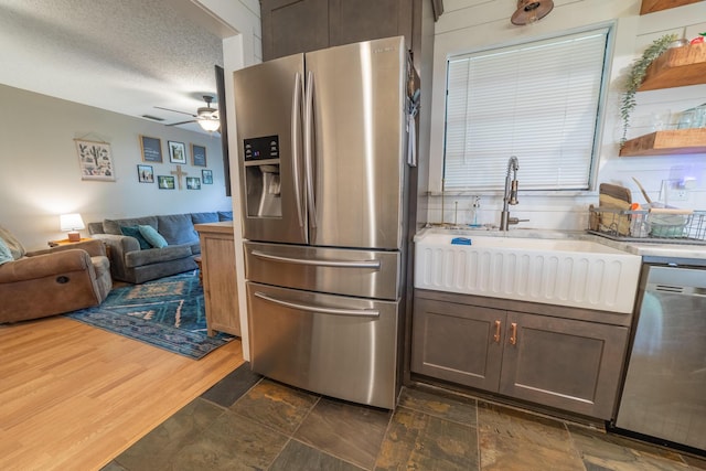 1793 SW 22nd Ter, Okeechobee, FL 34974 - kitchen with stainless steel appliances, a sink, light countertops, a ceiling fan, and open floor plan