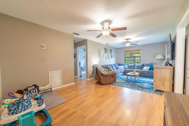 1793 SW 22nd Ter, Okeechobee, FL 34974 - living room with ceiling fan, a textured ceiling, and light wood-style flooring