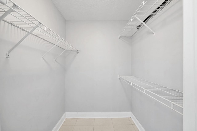 815 W Boynton Beach Blvd Unit 16-103, Boynton Beach, FL 33426 - walk in closet featuring light tile patterned floors