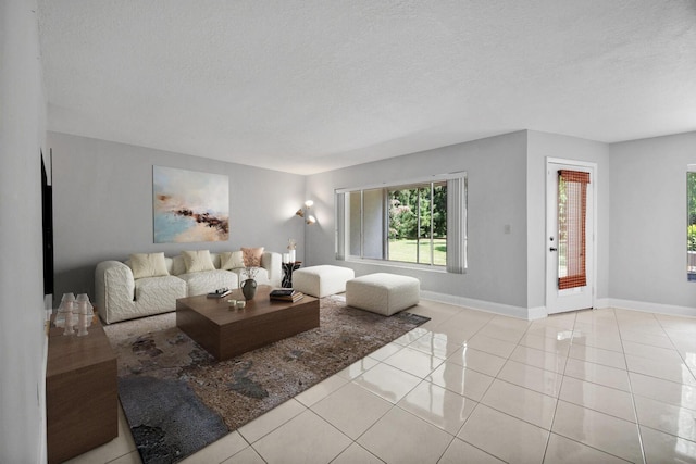 815 W Boynton Beach Blvd Unit 16-103, Boynton Beach, FL 33426 - tiled living room with baseboards and a textured ceiling