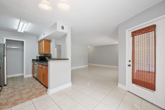 815 W Boynton Beach Blvd Unit 16-103, Boynton Beach, FL 33426 - kitchen featuring dark countertops, brown cabinetry, stainless steel appliances, light tile patterned floors, and baseboards