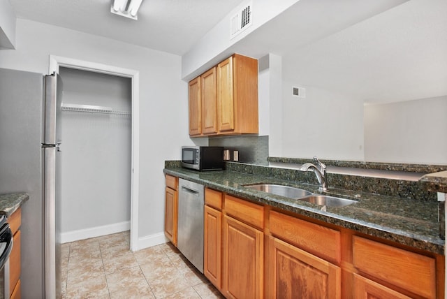 815 W Boynton Beach Blvd Unit 16-103, Boynton Beach, FL 33426 - kitchen with stainless steel appliances, a sink, dark stone countertops, baseboards, and light tile patterned flooring