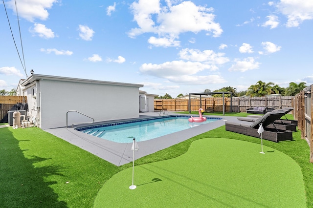 2137 Longwood Rd, West Palm Beach, FL 33409 - view of swimming pool with a putting green and a fenced backyard