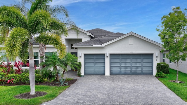 11051 SW Ivory Springs Ln, Port Saint Lucie, FL 34987 - view of front of property with a garage, driveway, stucco siding, and a front yard