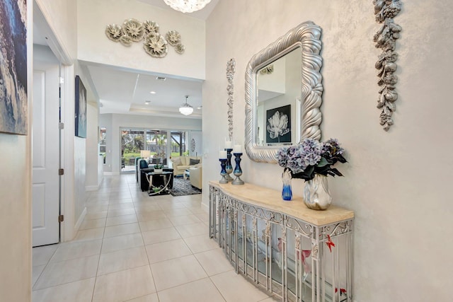 11051 SW Ivory Springs Ln, Port Saint Lucie, FL 34987 - corridor with tile patterned flooring, baseboards, and a raised ceiling