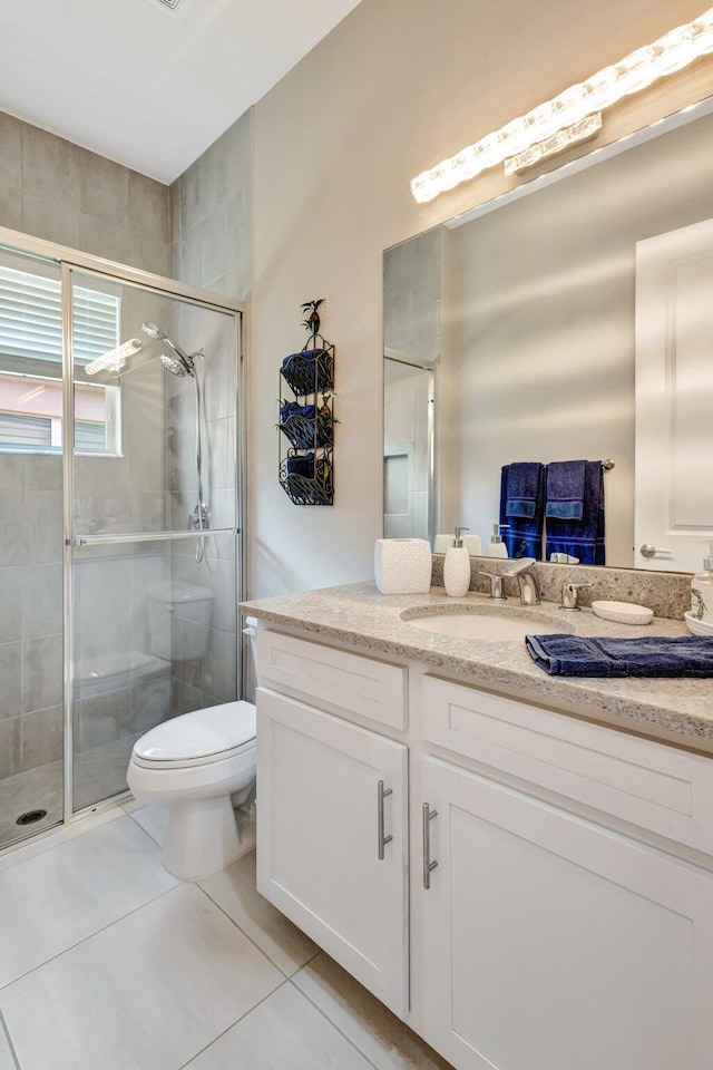 11051 SW Ivory Springs Ln, Port Saint Lucie, FL 34987 - bathroom featuring vanity, toilet, a shower stall, and tile patterned flooring