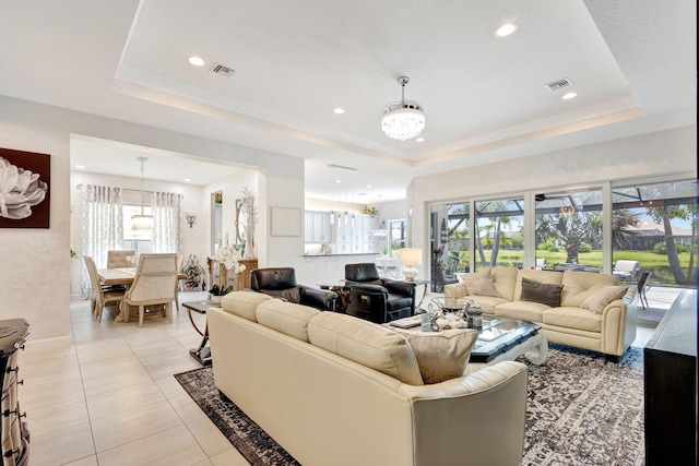 11051 SW Ivory Springs Ln, Port Saint Lucie, FL 34987 - living area featuring a chandelier, a tray ceiling, light tile patterned flooring, recessed lighting, and baseboards