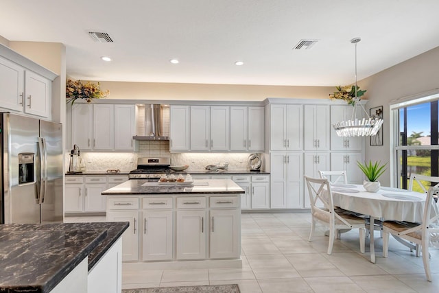 11051 SW Ivory Springs Ln, Port Saint Lucie, FL 34987 - kitchen featuring stainless steel appliances, wall chimney range hood, decorative backsplash, hanging light fixtures, and a center island