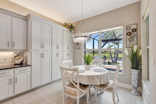 11051 SW Ivory Springs Ln, Port Saint Lucie, FL 34987 - dining room with light tile patterned floors, a chandelier, and baseboards
