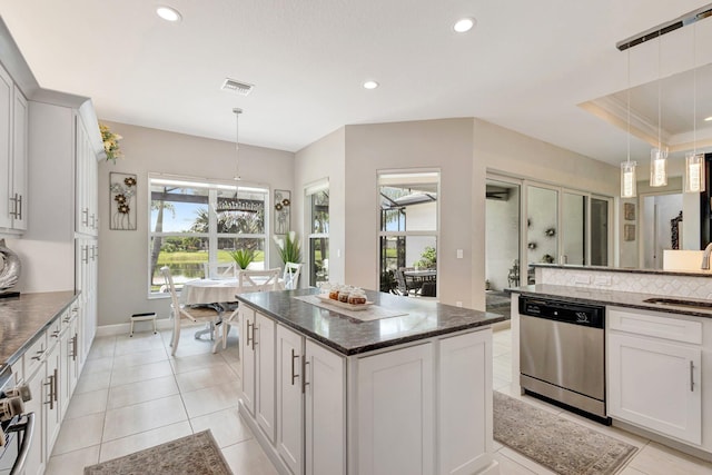 11051 SW Ivory Springs Ln, Port Saint Lucie, FL 34987 - kitchen featuring stainless steel appliances, recessed lighting, a kitchen island, white cabinetry, and dark stone counters