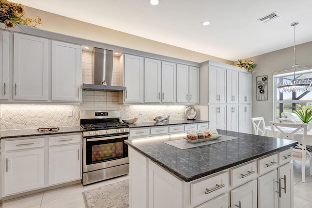 11051 SW Ivory Springs Ln, Port Saint Lucie, FL 34987 - kitchen with gas stove, wall chimney exhaust hood, light tile patterned floors, tasteful backsplash, and recessed lighting