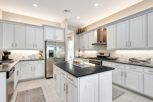 11051 SW Ivory Springs Ln, Port Saint Lucie, FL 34987 - kitchen featuring stainless steel appliances, wall chimney range hood, a sink, backsplash, and recessed lighting