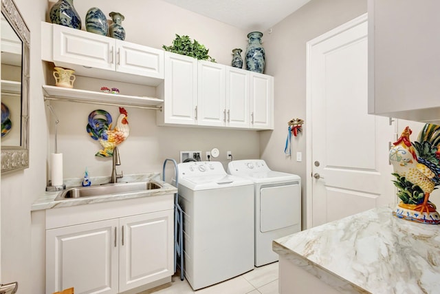 11051 SW Ivory Springs Ln, Port Saint Lucie, FL 34987 - laundry area with washing machine and clothes dryer, cabinet space, and light tile patterned floors