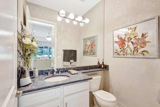 11051 SW Ivory Springs Ln, Port Saint Lucie, FL 34987 - bathroom featuring toilet, vanity, and baseboards