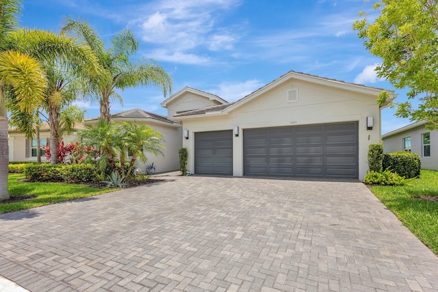11051 SW Ivory Springs Ln, Port Saint Lucie, FL 34987 - single story home featuring decorative driveway, a garage, and stucco siding