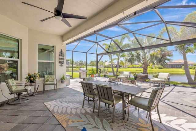 11051 SW Ivory Springs Ln, Port Saint Lucie, FL 34987 - view of patio / terrace featuring a water view, outdoor dining space, ceiling fan, and glass enclosure