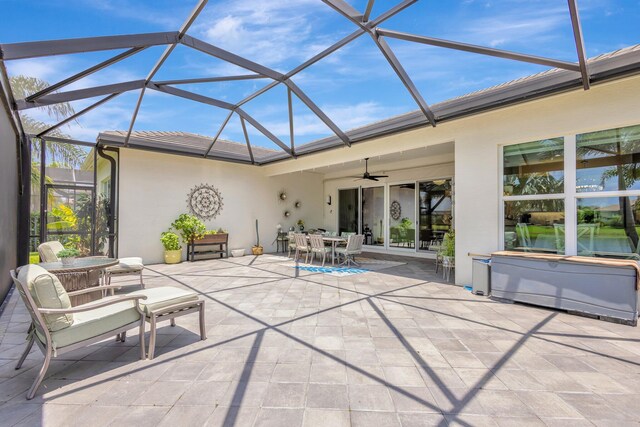 11051 SW Ivory Springs Ln, Port Saint Lucie, FL 34987 - view of patio / terrace with outdoor dining area, a ceiling fan, and glass enclosure