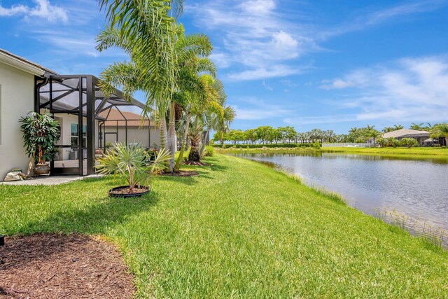 11051 SW Ivory Springs Ln, Port Saint Lucie, FL 34987 - view of green lawn with a water view and glass enclosure