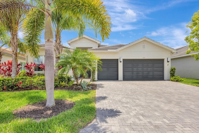 11051 SW Ivory Springs Ln, Port Saint Lucie, FL 34987 - single story home with decorative driveway, a garage, and stucco siding