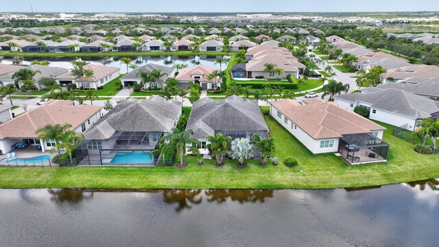 11051 SW Ivory Springs Ln, Port Saint Lucie, FL 34987 - aerial perspective of suburban area with a pool area and a large body of water